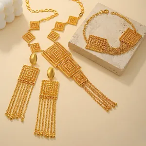 Detailed close-up of gold-plated layered square necklace and fringe earrings set