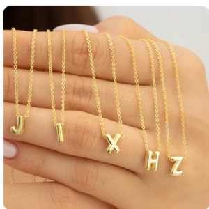 Gold bubble initial pendant necklace for women featuring a minimalist letter design