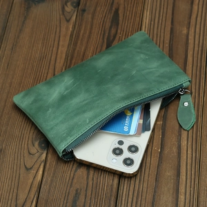 Detailed close-up of green crazy horse leather wallet showing phone and card slots