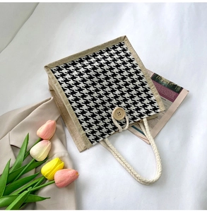 Detail of houndstooth tote bag with wooden button closure and cotton rope handles