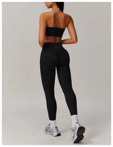 Detail of high-waist black yoga pants with scrunch butt lifting design for fitness