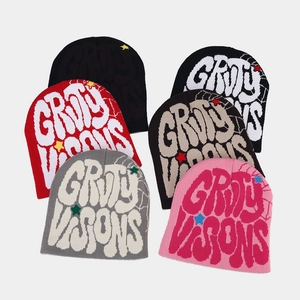 Knit beanies with Groovy Visions text and star patterns in multiple colors