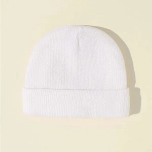 Detail of white ribbed knit beanie for kids showing the soft acrylic texture and cuff