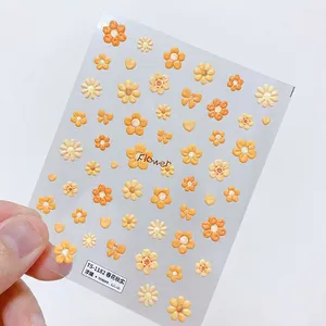 Detailed macro view of 3D embossed nail stickers featuring orange daisies and tulips