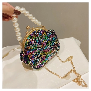 Detail of colorful sequin shell bag with large pearl handle and metal kiss-lock closure