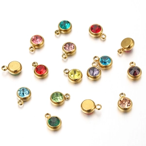 Close-up of colorful round crystal pendants with gold metal bases and jump rings