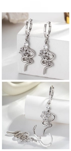 Macro view of silver snake drop earrings with snowflake zirconia and leverback clasp