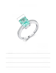 Detail view of emerald cut Paraiba blue stone on a S925 sterling silver ring band