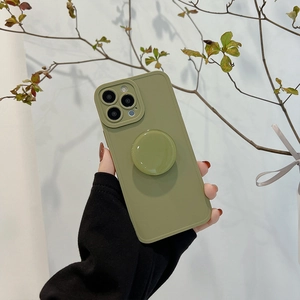 Macro shot of green iPhone case featuring a matching circular pop-up phone stand