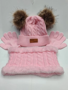 Flat lay of pink knit winter set featuring a double pompom hat, scarf, and gloves
