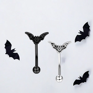 Close-up of black and silver stainless steel bat curved barbells for body piercing