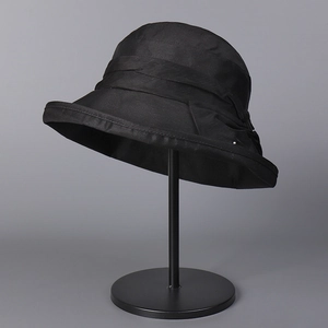 Close-up of black Lyocell linen blend sun hat featuring layered pleats and metal detail