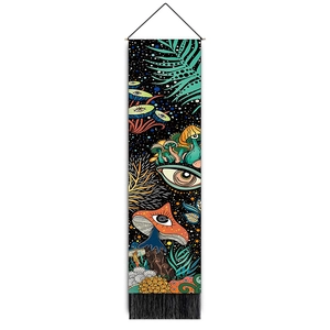 Close-up of colorful mushroom tapestry with wooden hanging rod and black tassels