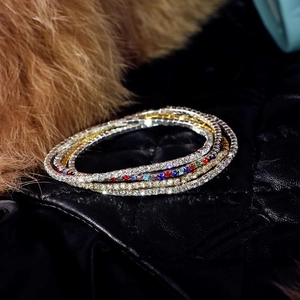 Macro view of multi-color rhinestone stretch bracelets on black leather and fur