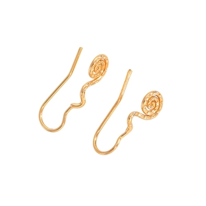 Macro detail of gold wavy drop earrings featuring spiral textured circular disks