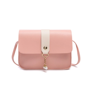 Pale pink crossbody bag with pearl charm and white strap detail on white background