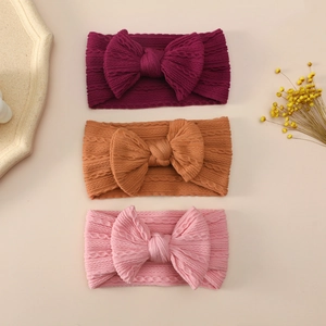 Detailed cable-knit texture of high-elasticity nylon baby bow headbands in three colors