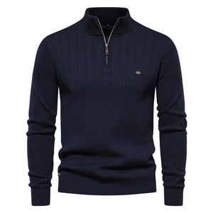 Detailed close-up of navy blue knit sweater with half-zip stand collar and metal accent