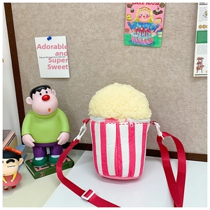 Detail view of popcorn shaped plush crossbody bag with pink stripes and adjustable red strap