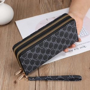 Detail of grey double zipper long wallet showing side thickness and canvas texture
