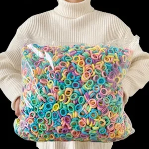 Bulk pack of colorful macaron hair ties in transparent packaging shown by a model