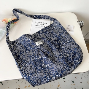 Detail of blue paisley canvas tote bag with wide straps and spacious interior