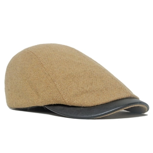 Mustard yellow vintage wool beret with black leather brim and herringbone texture