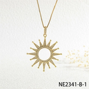 Detailed shot of a sunburst pendant necklace with cubic zirconia in gold plating