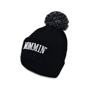 Knit beanie hat in black with MOMMIN embroidery and a grey faux fur pom pom top