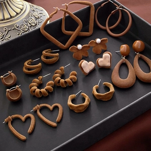 Macro shot of assorted brown and beige flocked velvet earrings with pearl accents