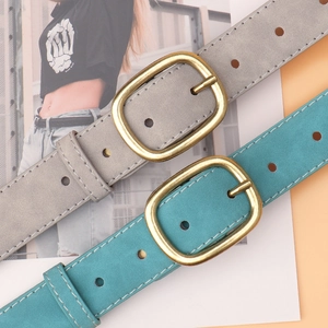 Grey and teal suede belts with brass oval buckles and white stitching details