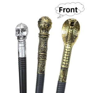 Detailed front view of three decorative staff heads: skull, globe, and cobra designs
