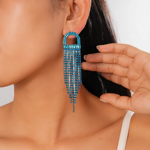 Close-up of blue zircon jellyfish fringe earrings on model with dangling tassels