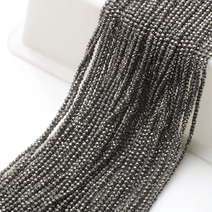 Close-up of 2mm faceted dark grey glass beads for DIY jewelry and beaded necklaces