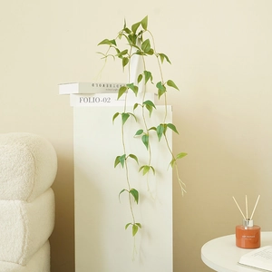 Artificial hanging clematis vine for indoor and outdoor wall decor in minimalist setting