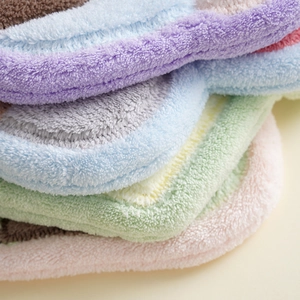 Close-up of soft coral fleece texture showing plush fibers in various pastel colors