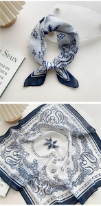 Detailed macro view of white and navy paisley printed linen-cotton square neck scarf