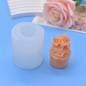Ice cream flower silicone mold with finished orange cupcake candle on blue background