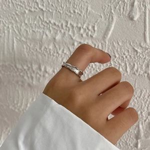 Close-up of S925 sterling silver ring with irregular wrinkled texture on a hand