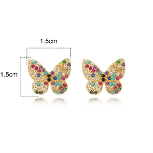 Macro shot of butterfly stud earrings with colorful zircons and 1.5cm dimension markings
