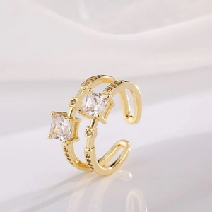 Double-layered gold-plated ring with two square zircon stones in a minimalist open design