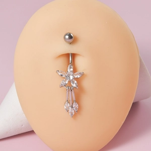 Detail of silver floral belly ring with crystal tassels on model, showing zircon stones