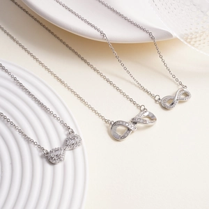 Elegant silver infinity necklace with sparkling zircon pendant on white tray