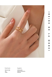 Macro detail of 18K gold-plated double-layer ring featuring a star and beaded edge