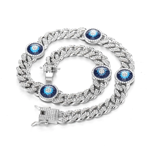 Iced-out Cuban link bracelet with blue evil eye charms and rhinestone inlay for hip hop style