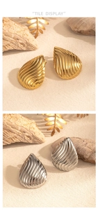 Detail view of gold and silver teardrop earrings with elegant striped texture and shine