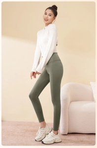 Detail view of high waisted olive green yoga pants with tummy control and lifting design