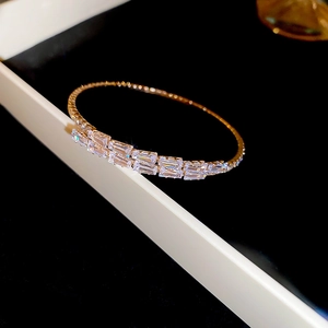 Macro detail of gold plated bracelet with double row rectangular cubic zirconia stones