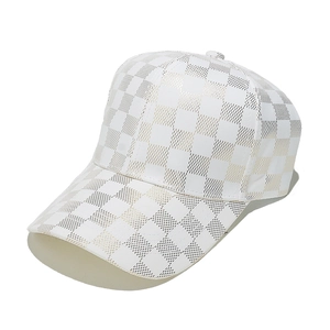 Detail of white and gold checkered baseball cap with laser-cut ventilation holes