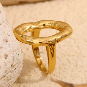 Macro shot of 18K gold-plated irregular ring with unique hammered lava texture finish